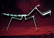 This metal armature, left, became the final praying mantis puppet on the right when encased in a cast foam latex exterior. All elements were constructed by Tom Brierton.